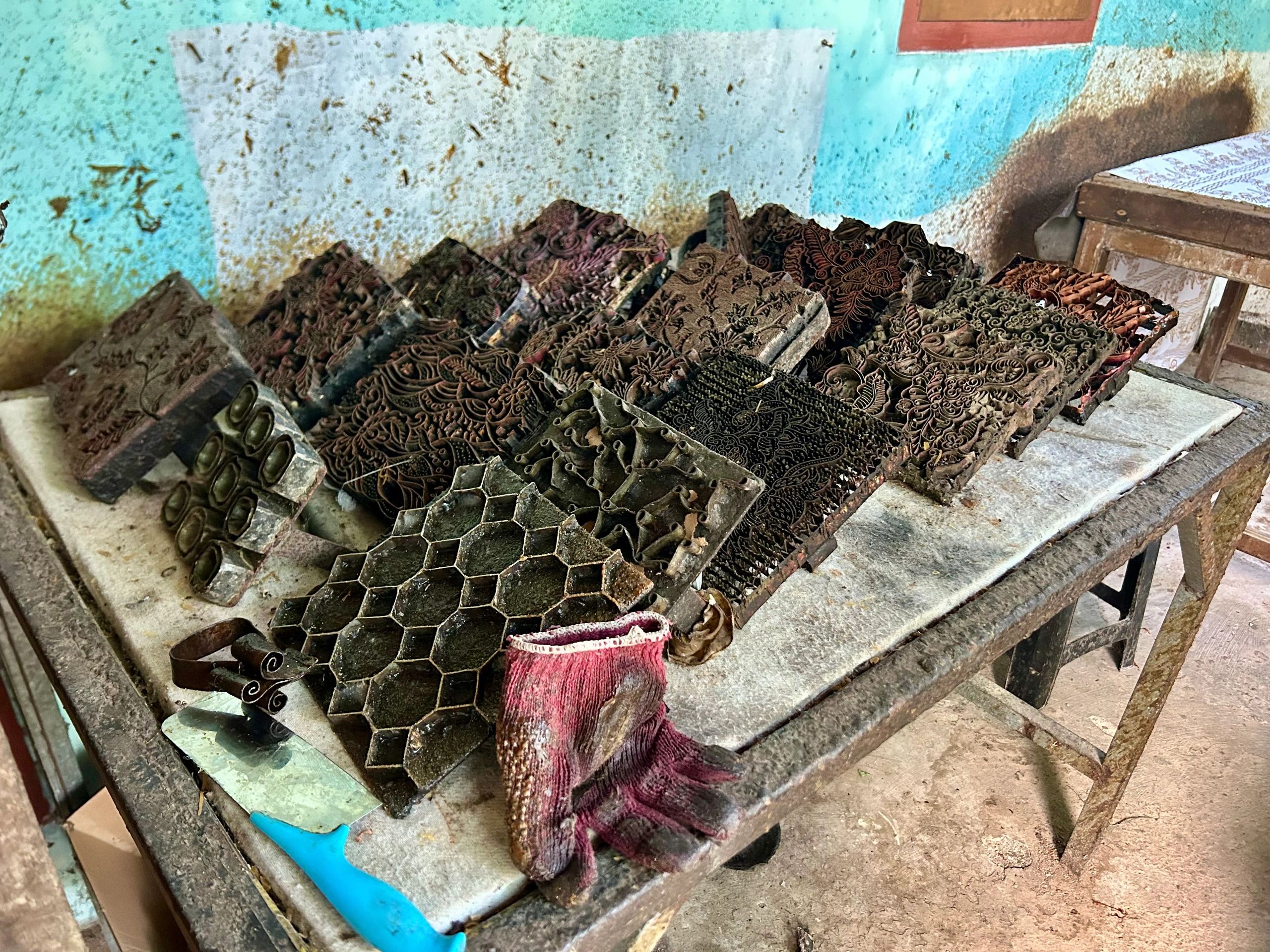 Traditional metal tools displayed across a workbench